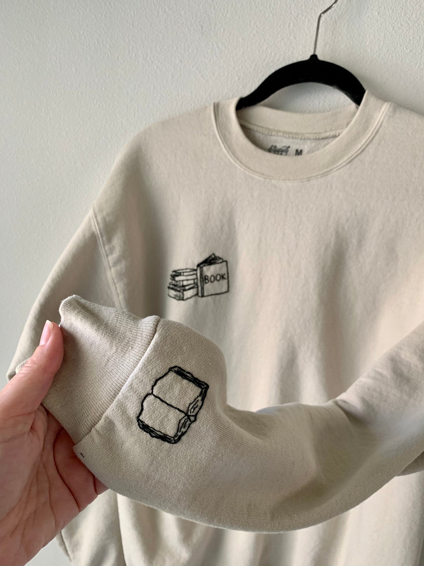 Made to Order Hand Embroidered Book Stack with Open Book on Sleeve, Tan Crewneck Fleece Long Sleeve Pullover Sweatshirt, Unisex, Bookstagram