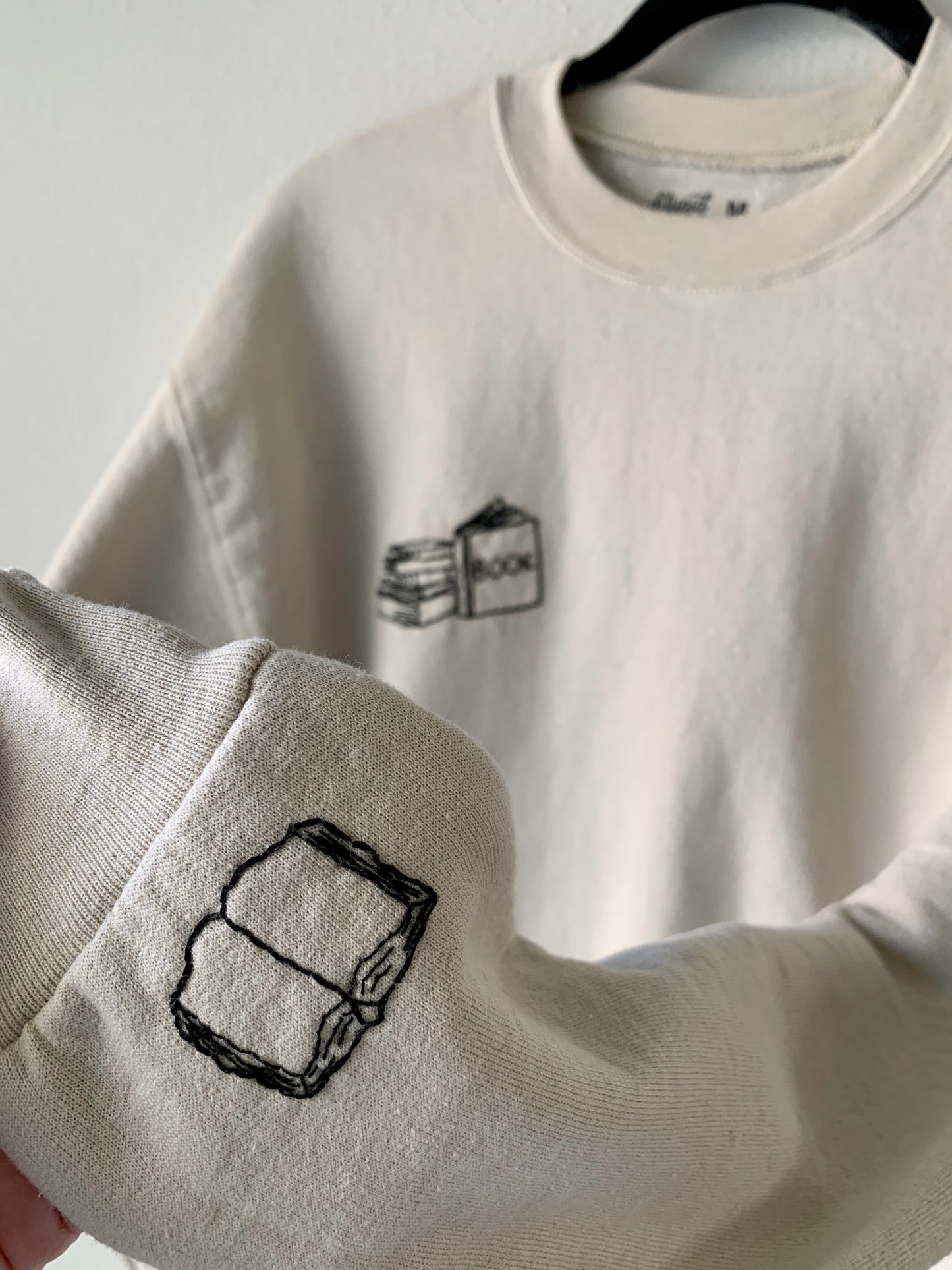 Made to Order Hand Embroidered Book Stack with Open Book on Sleeve, Tan Crewneck Fleece Long Sleeve Pullover Sweatshirt, Unisex, Bookstagram